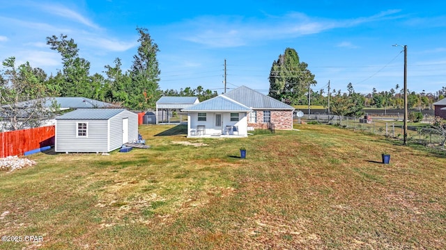 back of property with a yard and a storage unit