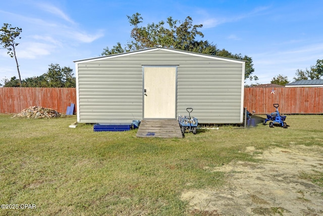 view of outdoor structure featuring a lawn