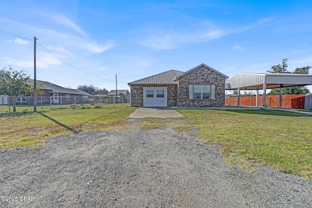 single story home featuring a garage and a front lawn