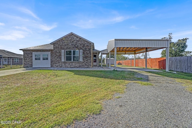 view of front of house with a carport, a garage, and a front lawn