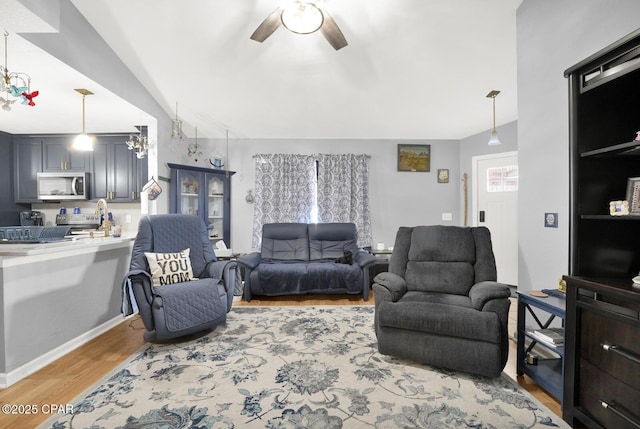 living room featuring ceiling fan and light hardwood / wood-style floors