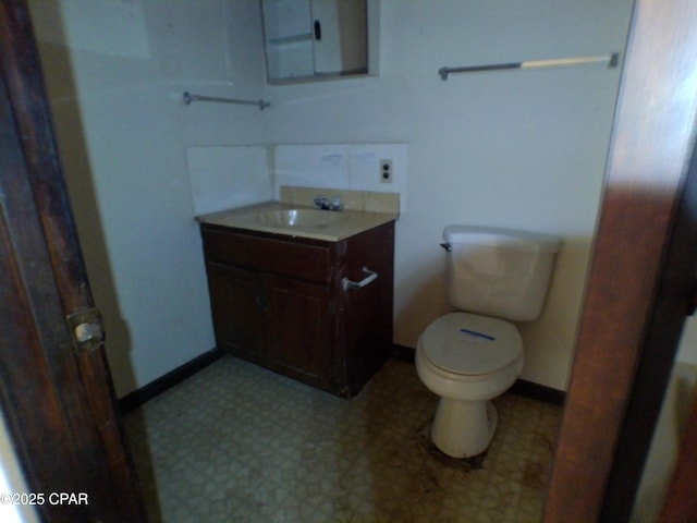 bathroom featuring toilet and vanity