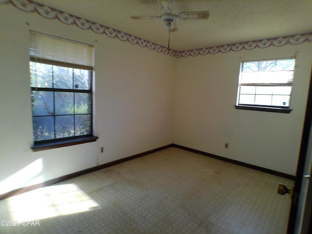 spare room with carpet, ceiling fan, and a healthy amount of sunlight