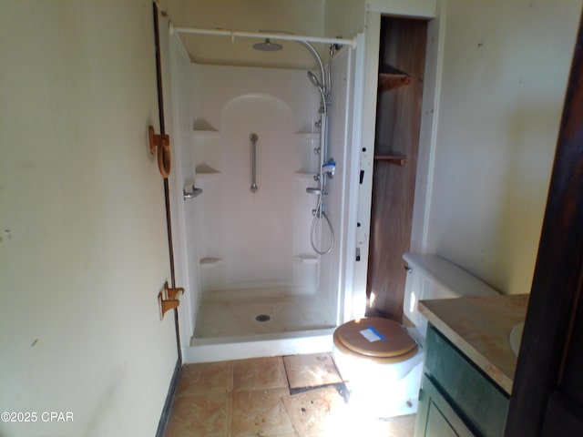 bathroom featuring a shower, toilet, and vanity