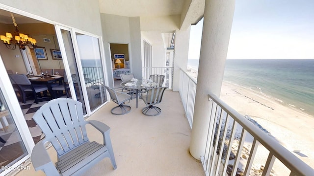 balcony with a water view and a beach view