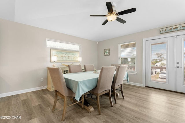 dining area featuring french doors, baseboards, ceiling fan, and light wood finished floors