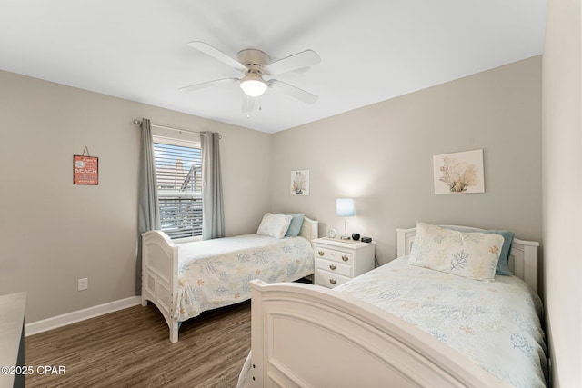 bedroom with baseboards, dark wood finished floors, and a ceiling fan