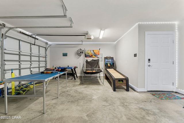 garage featuring a garage door opener and baseboards