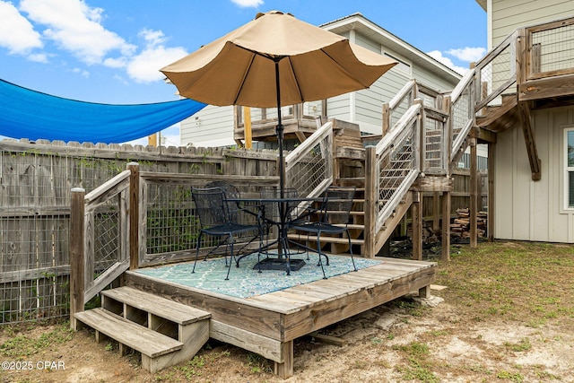 deck featuring stairway and fence