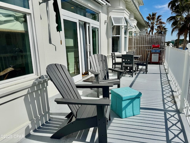 view of patio with outdoor dining area and fence