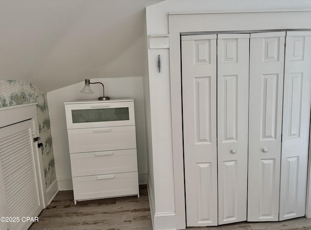 laundry room with baseboards and wood finished floors