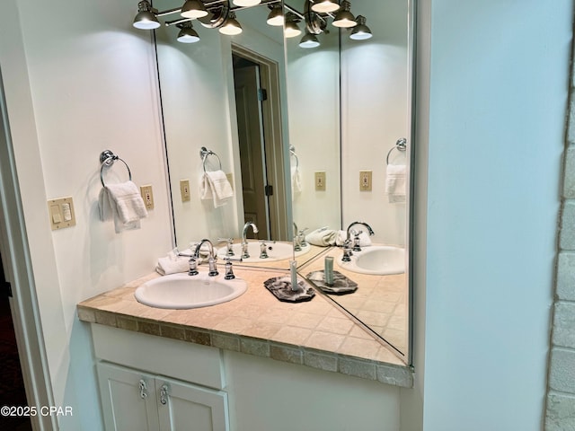 bathroom with a notable chandelier and vanity