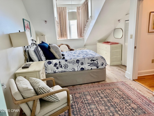 bedroom featuring wood finished floors and baseboards