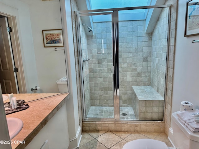 full bath featuring a shower stall, vanity, and toilet