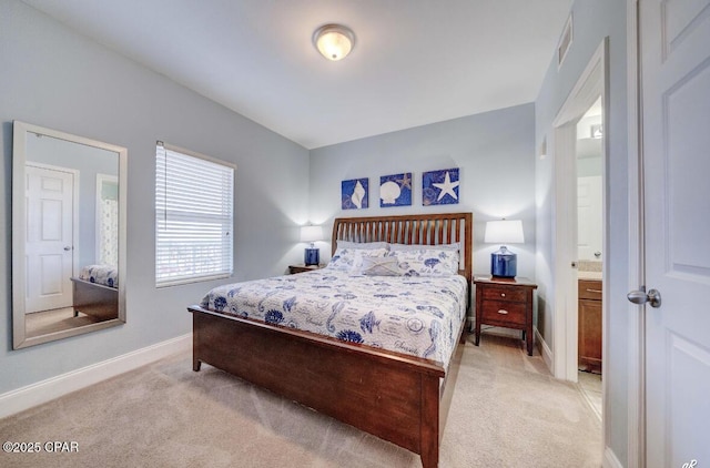 carpeted bedroom with ensuite bath