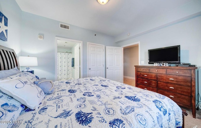 carpeted bedroom with ensuite bath