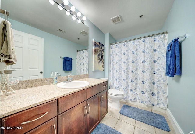 bathroom featuring vanity, tile patterned flooring, and toilet