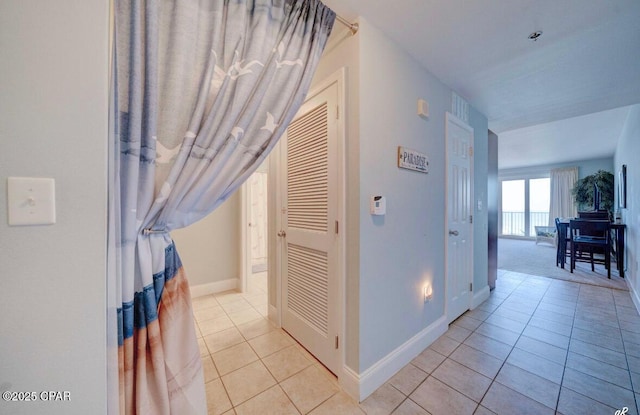 hall with light tile patterned floors