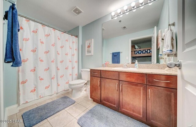 bathroom with tile patterned flooring, vanity, a shower with curtain, and toilet