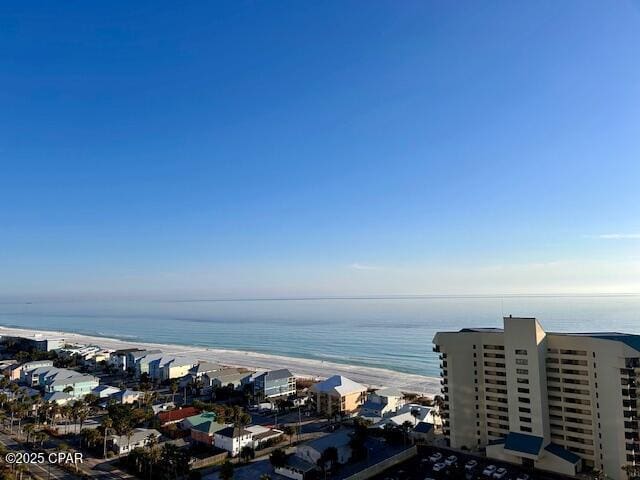 birds eye view of property with a water view and a beach view