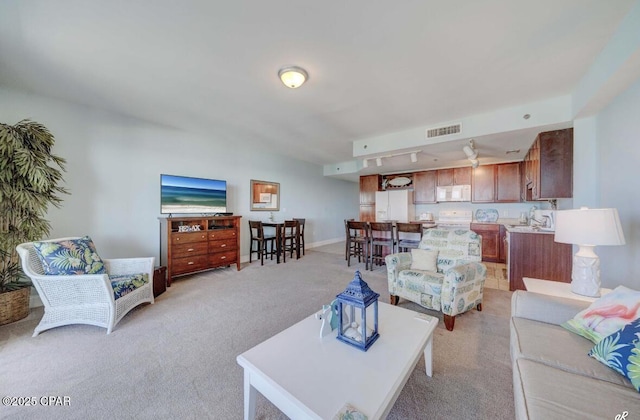 carpeted living room featuring sink