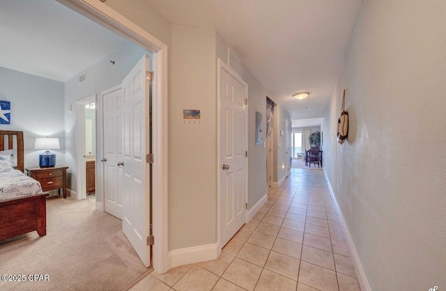 hall with light tile patterned floors