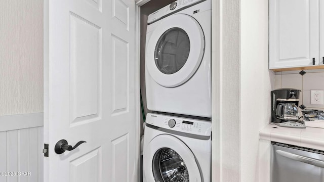 laundry room with stacked washer / drying machine