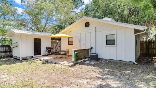 rear view of house with an outdoor structure