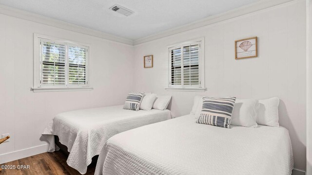 bedroom featuring ornamental molding and dark hardwood / wood-style floors