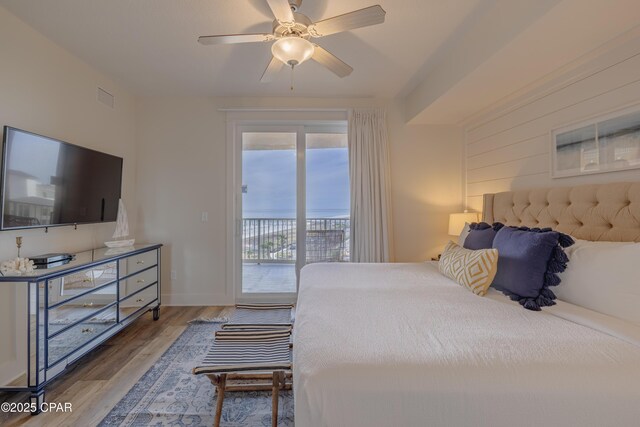 bedroom with ceiling fan, access to exterior, and hardwood / wood-style floors