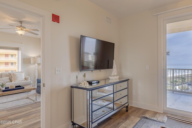 living room featuring wood-type flooring and ceiling fan