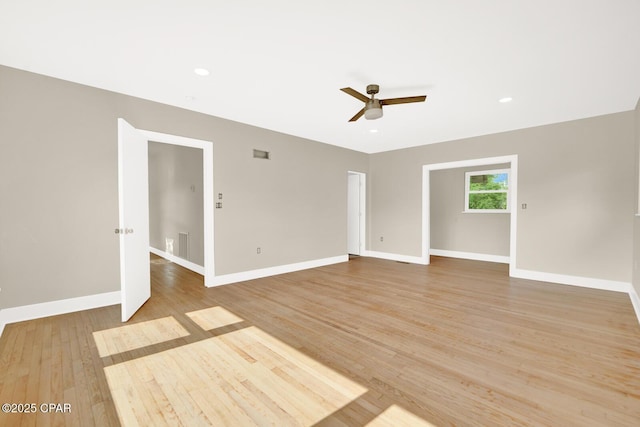 unfurnished room with ceiling fan and light wood-type flooring