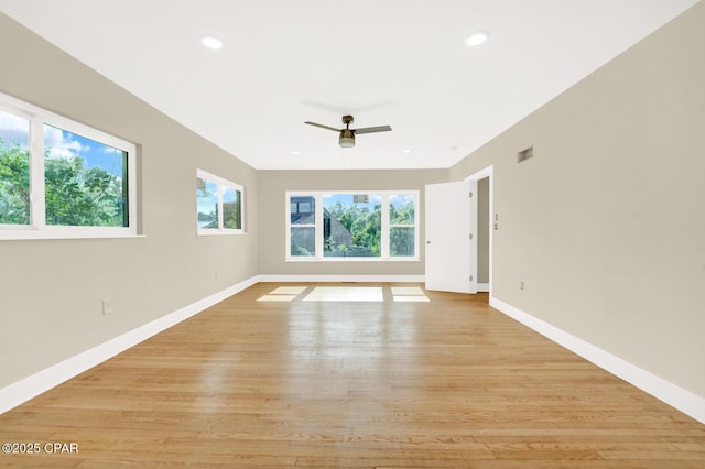 unfurnished room with ceiling fan and light hardwood / wood-style flooring