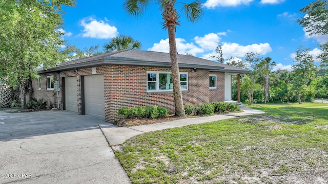 view of side of property featuring a garage and a lawn