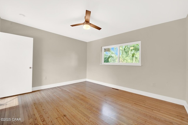 unfurnished room with hardwood / wood-style flooring and ceiling fan