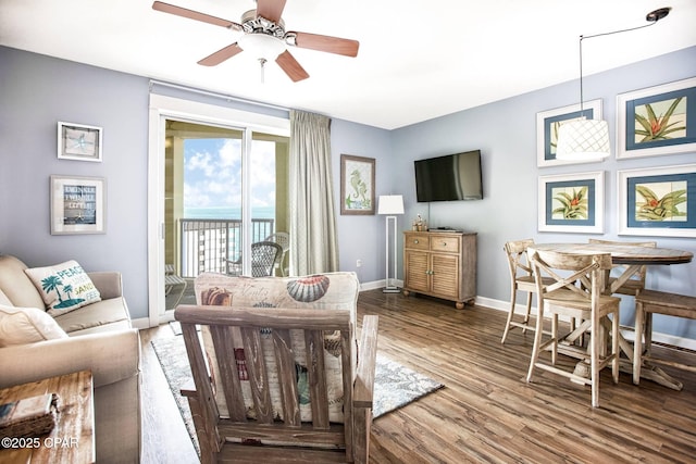 living room featuring hardwood / wood-style flooring and ceiling fan