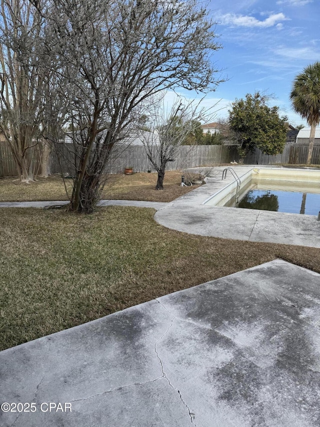 view of yard with a fenced in pool and a patio