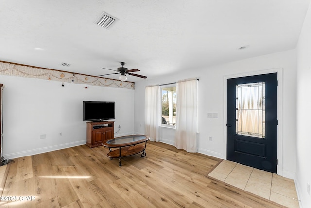 entrance foyer with light wood-style floors, baseboards, and visible vents