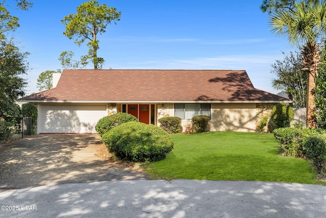 single story home with driveway, a front lawn, and an attached garage