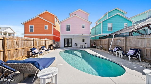 view of pool featuring french doors and a patio