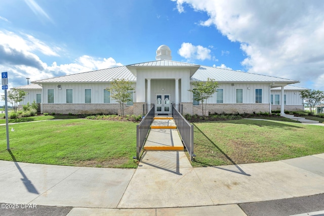 view of front of property with a front lawn and french doors