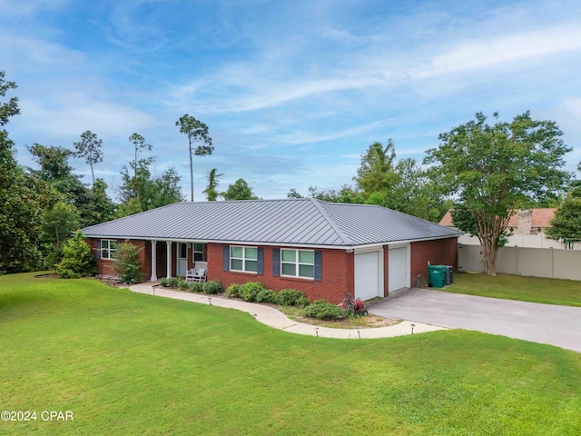 ranch-style home with a garage and a front lawn