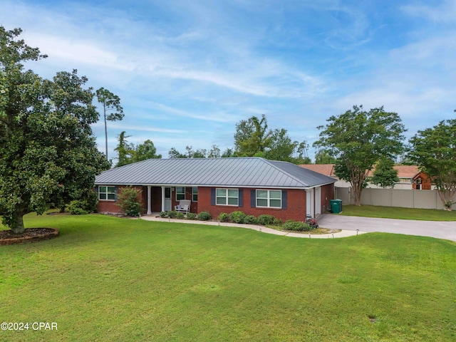 ranch-style house featuring a front yard and covered porch