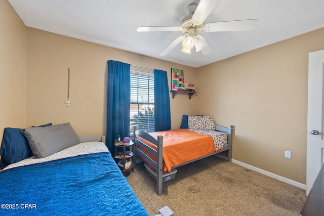 carpeted bedroom with a textured ceiling and ceiling fan