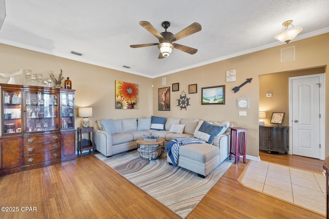 living room with crown molding, hardwood / wood-style floors, and ceiling fan