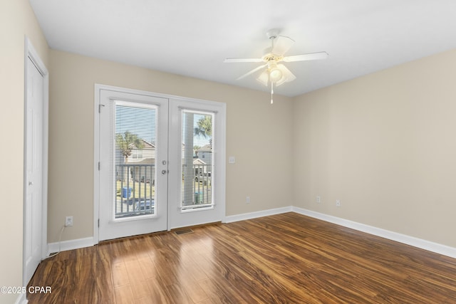 spare room featuring hardwood / wood-style floors, ceiling fan, and french doors