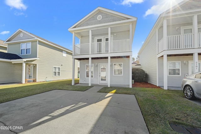 view of front of home with a porch, a balcony, and a front lawn