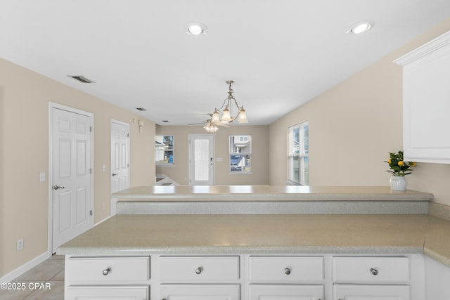 kitchen featuring white cabinetry, light tile patterned floors, and decorative light fixtures