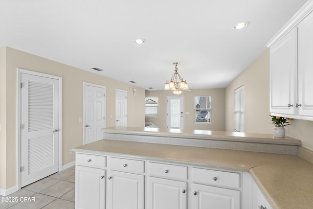 kitchen with white cabinetry, light tile patterned floors, and a chandelier