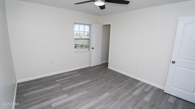 empty room with ceiling fan and hardwood / wood-style floors